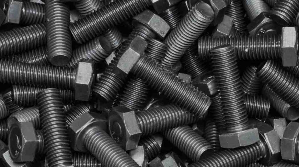 Pile of dark, black oxide finished hex bolts.