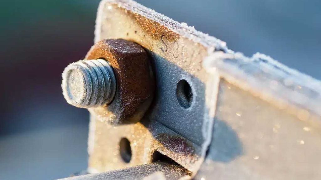 Close-up of a rusty, frosted metal fastener.