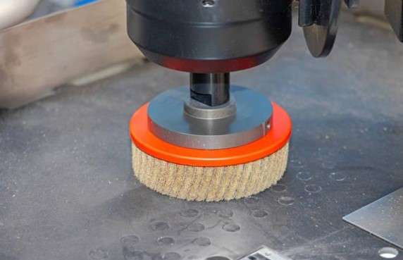 rough polishing tool working on a titanium part