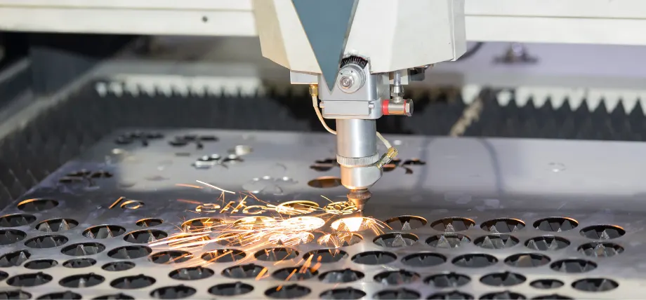 Laser cutting machine producing holes on a metal sheet with sparks