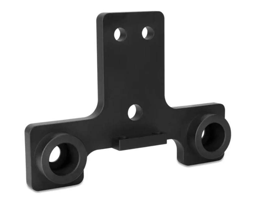 Image of a 3-axis CNC-machined bracket component with cylindrical bores and mounting holes