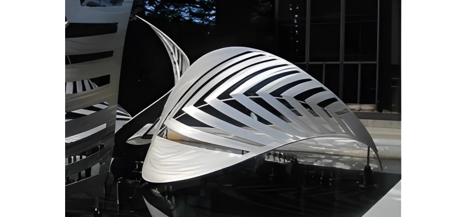 A large metal leaf structure precisely laser cut to form a leaf silhouette from aluminum.
