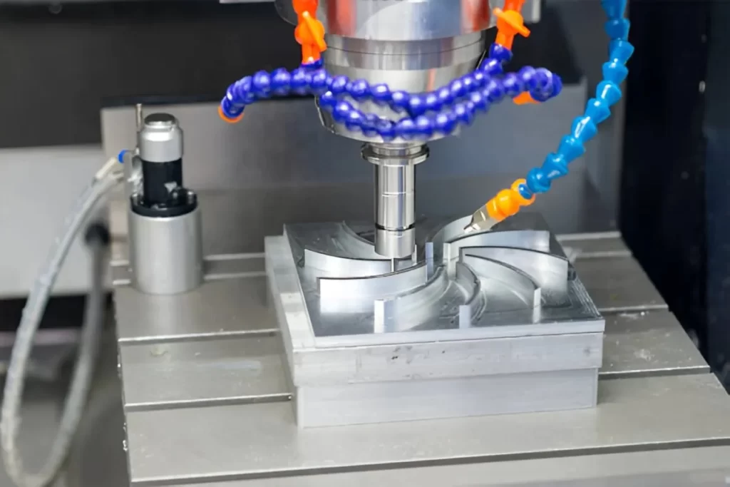 Aluminum part with complex blade features being machined.