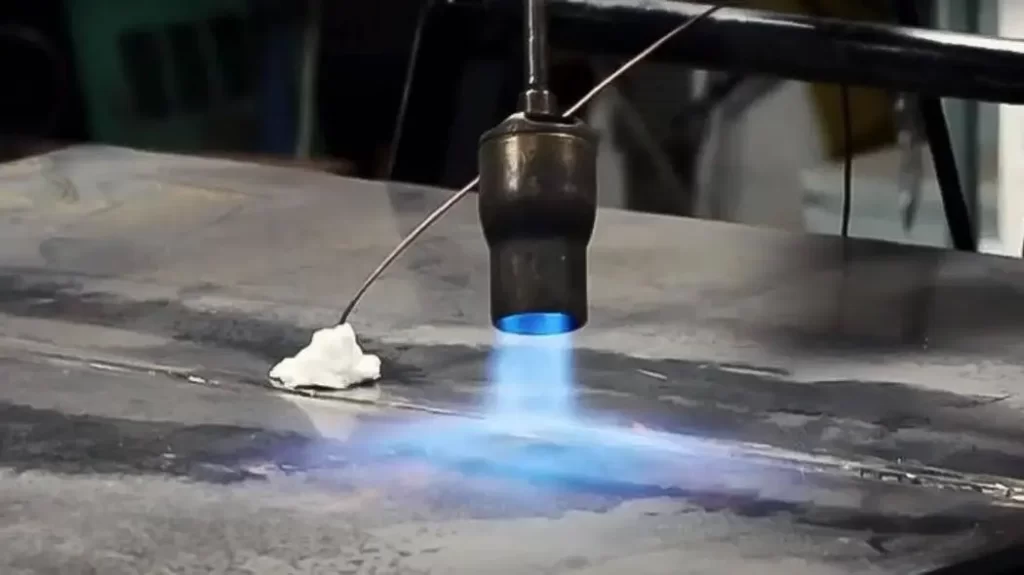 Close-up of aluminum being preheated before welding.