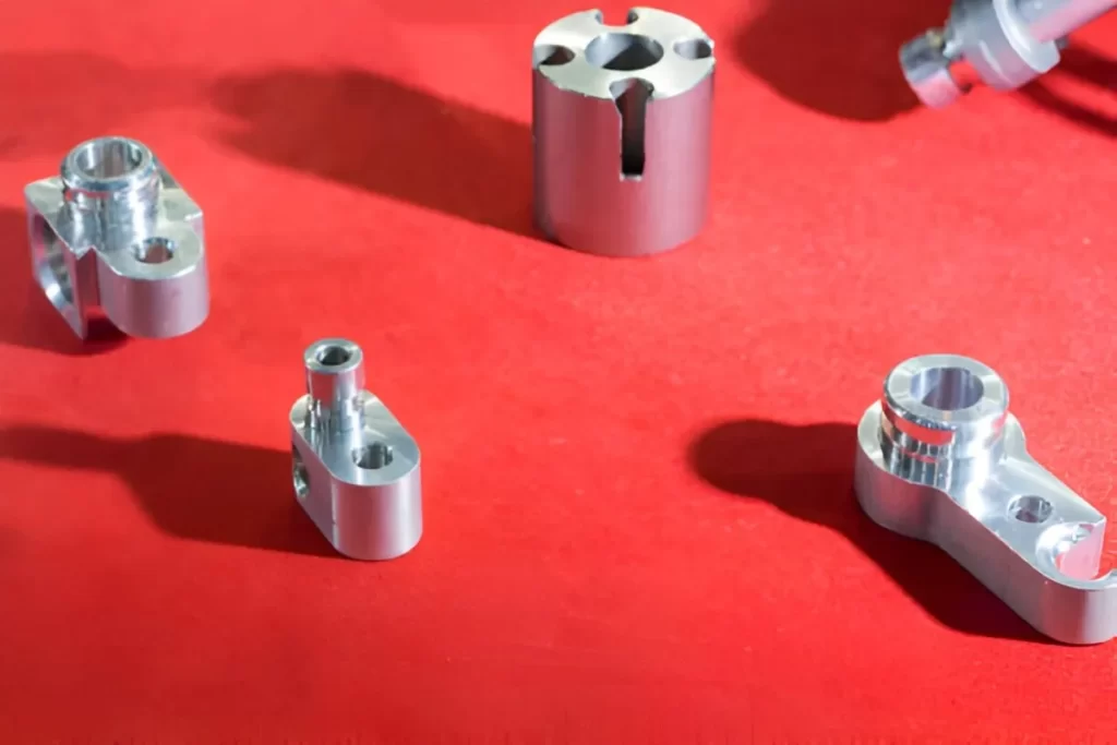 Displayed aluminum prototype and fixture parts.