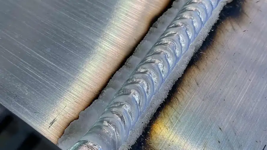 A Close-up of aluminum weld to unite two parts’ surfaces.