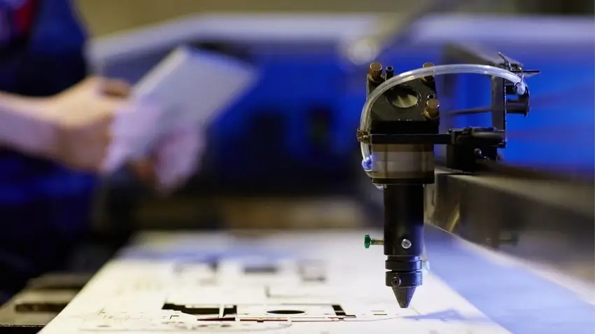 A CNC laser cutting machine at work uses a concentrated laser beam to cut through the material precisely