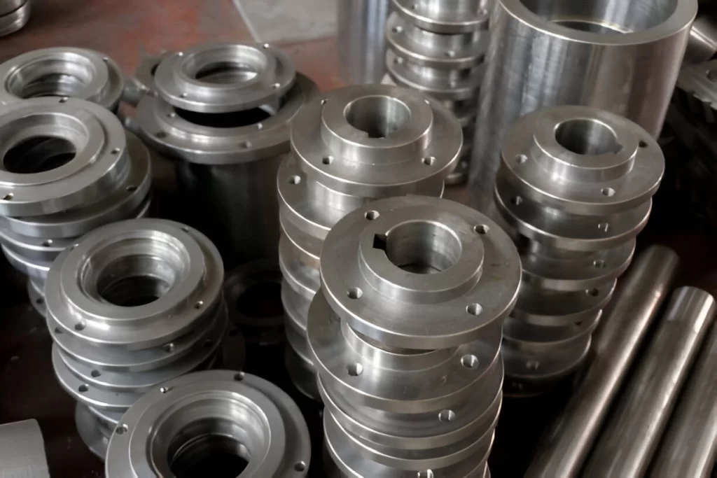 Close-up image of CNC-machined flanges stacked neatly in an organized arrangement.