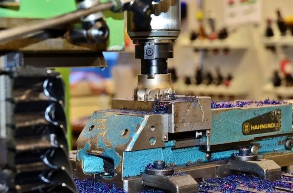 A CNC milling cutter machining a block of metal 