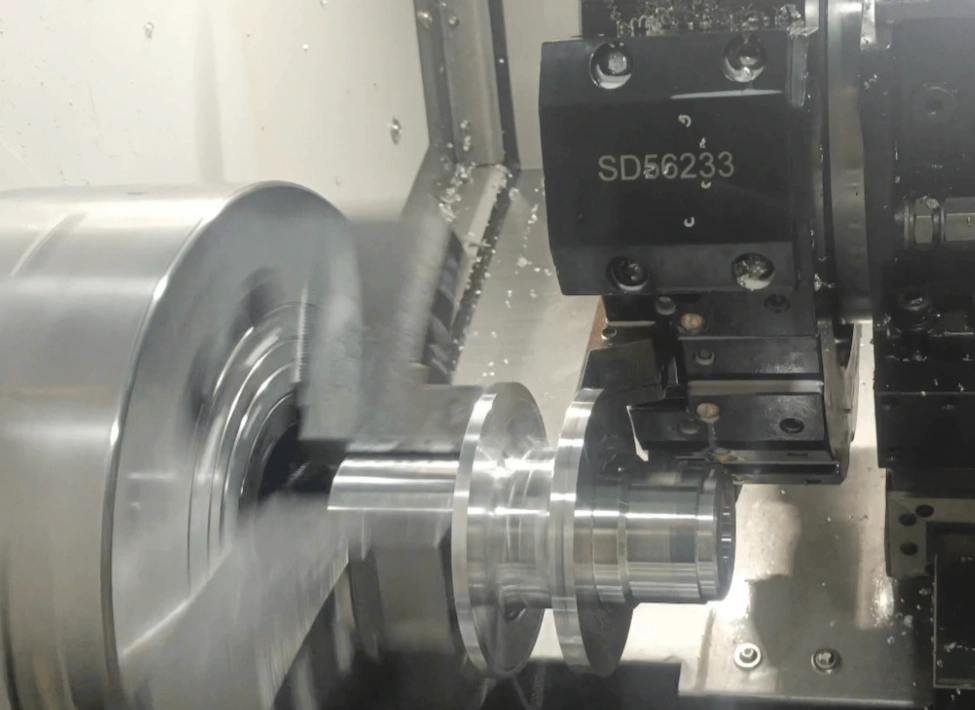 A metal prototype part being CNC turned