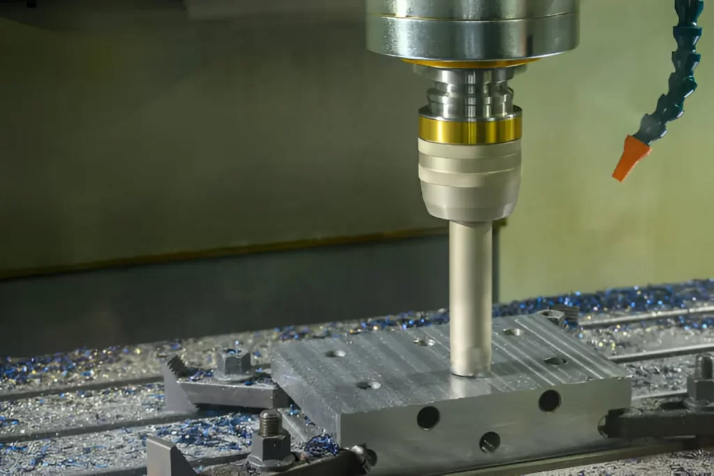 A tool milling the top surface of a metal piece.
