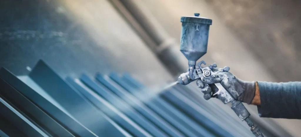 Spray painting galvanized steel panels for roofing