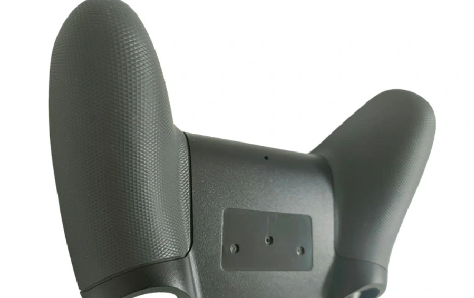 An image of a molded game controller handle with a plastic texture for good handling 