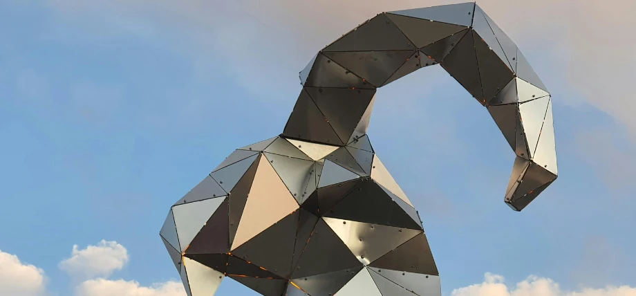 A simple standing garden sculpture placed outdoors.