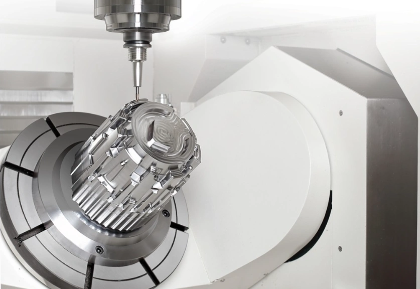 A shiny prototype part with many tiny contours on a multi-axis CNC machine