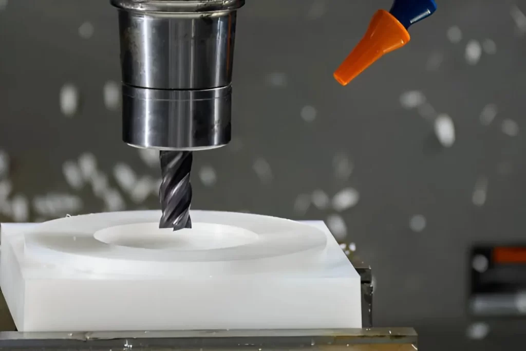 The image shows a nylon part being machined on a CNC setup. 