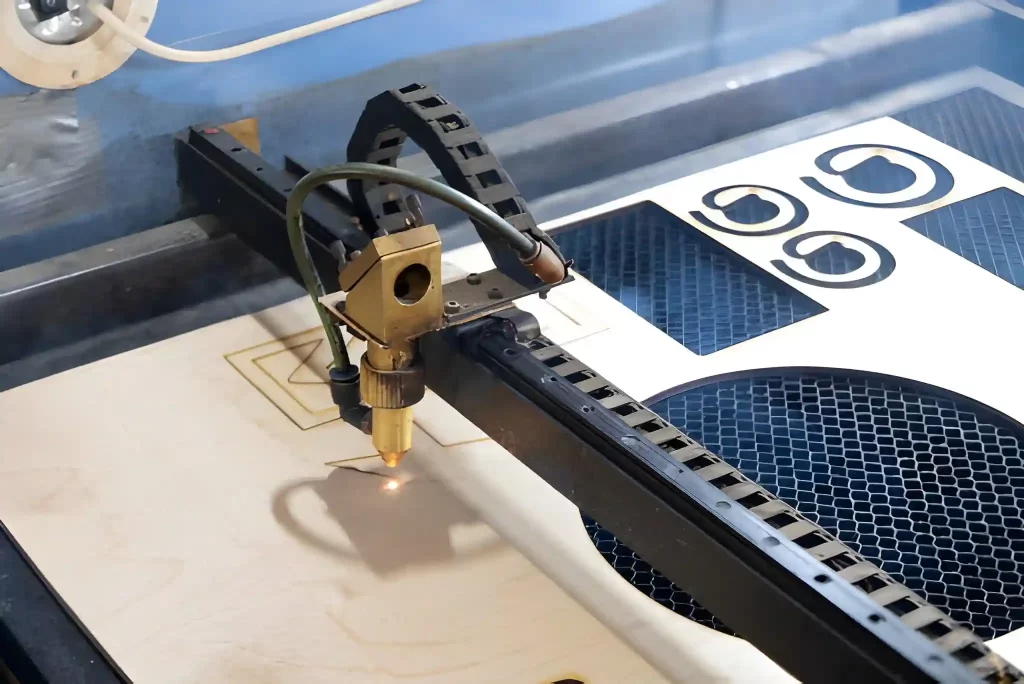 Laser cutter cuts star from plywood.