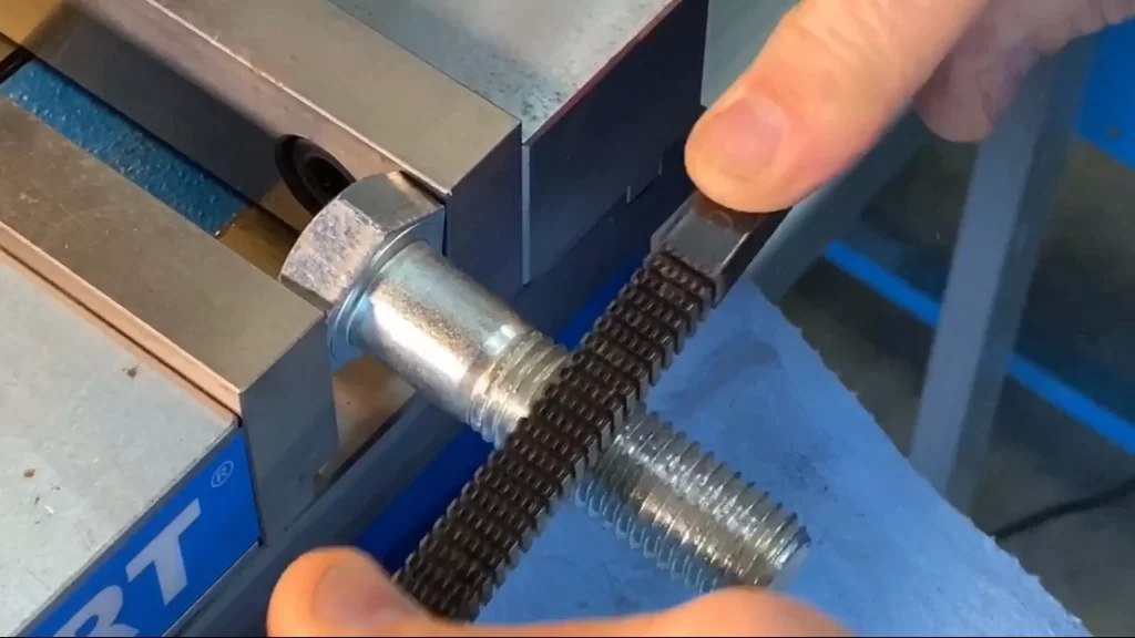 Fixing damaged bolt threads using a thread repair tool.