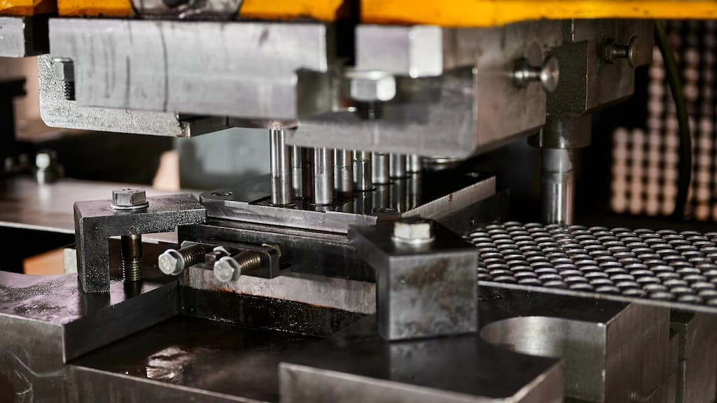 A close-up view of a sheet metal stamping setup