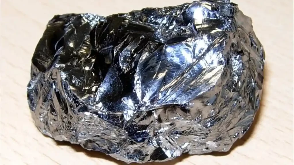 A close-up of a dark, metallic-looking chunk of the element silicon.
