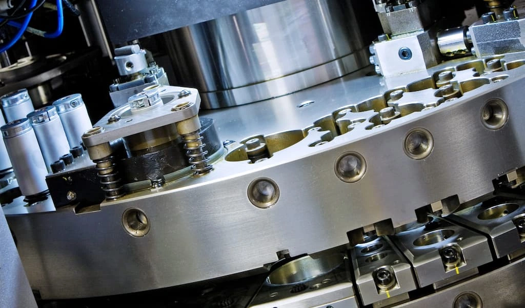 A close-up view of turret tooling equipped with multiple punches and dies.