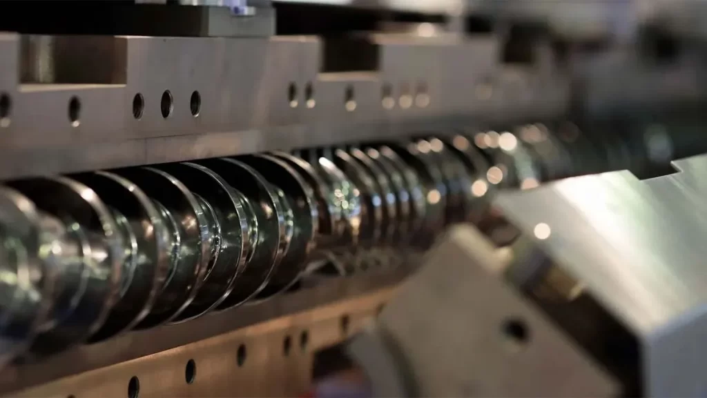 A close-up view of the mechanism within a plastic molding machine.