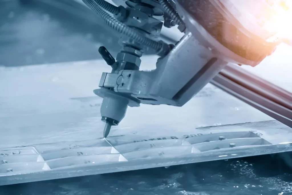 A waterjet Cutter cutting a metal sheet component.