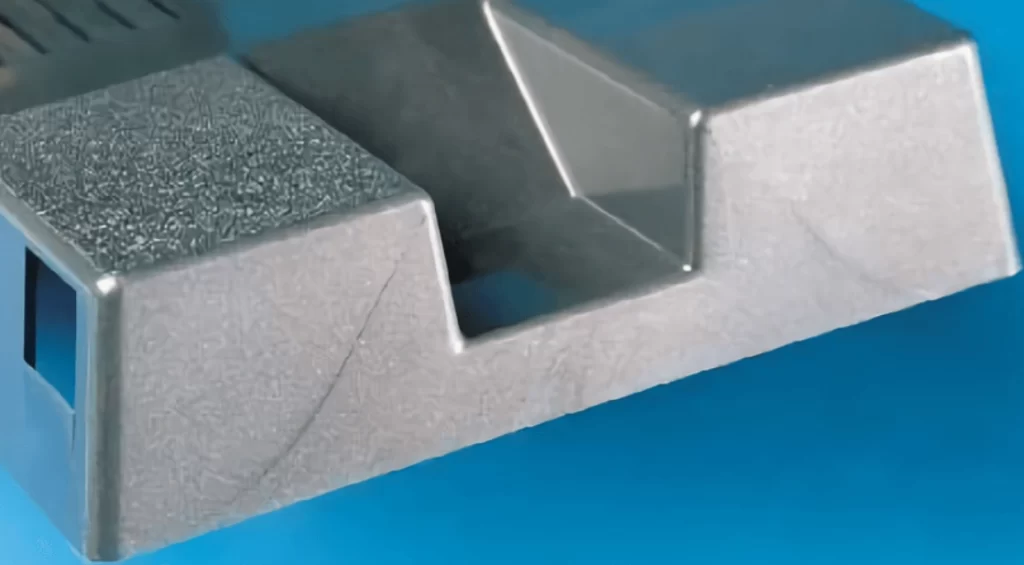 A grey plastic component showing a part of weld lines 